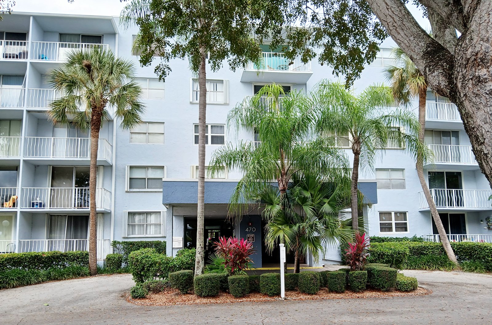 470 Executive Center Dr Front Entrance of Light Blue Condo Building