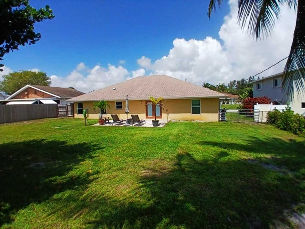 South Florida Real Estate • Luxury Homes Condos • The Martin Group 6640 Plymouth Drive N Lantana FL 33462 Back of House and Yard