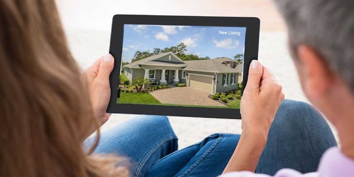 Couple Looking at iPad of House For Sale Image